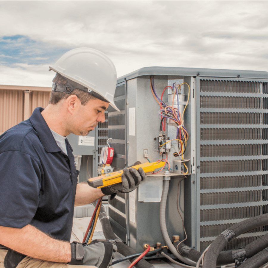 Elmira Heating & Cooling HVAC technician servicing a system